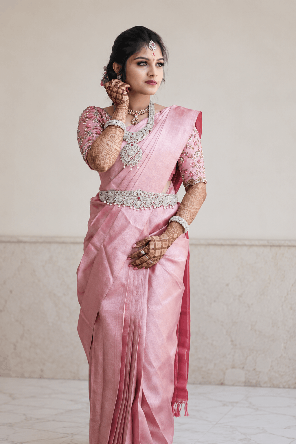 Elegant woman in deep rose pink silk saree with gold zari work